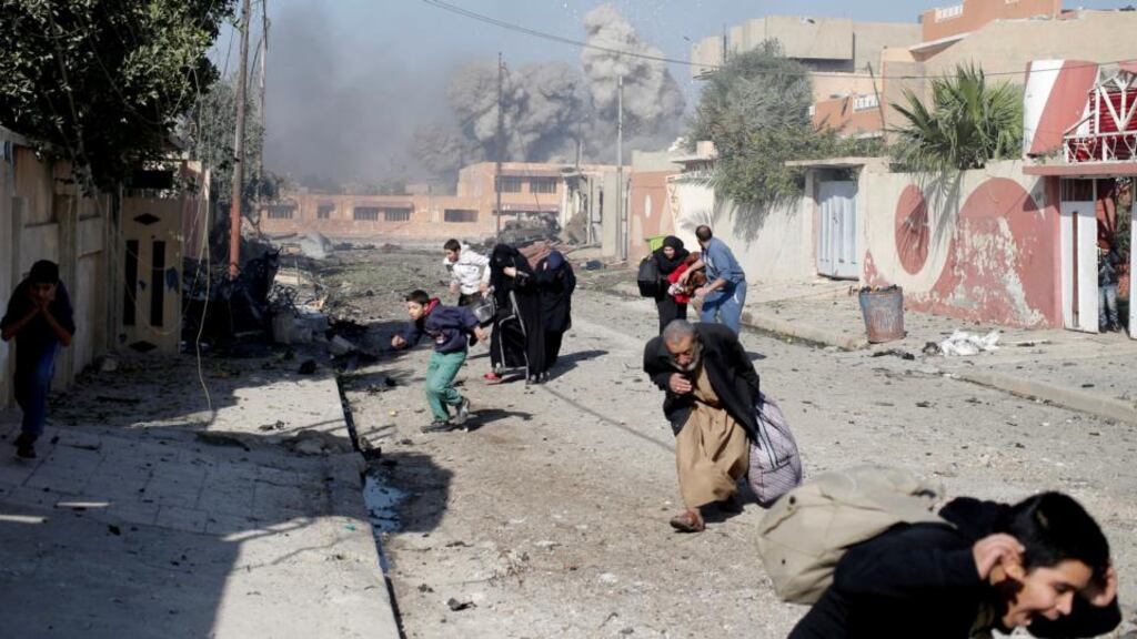 People flee after a coalition air strike hit Islamic State positions in Mosul. Photograph: Goran Tomasevic/Reuters