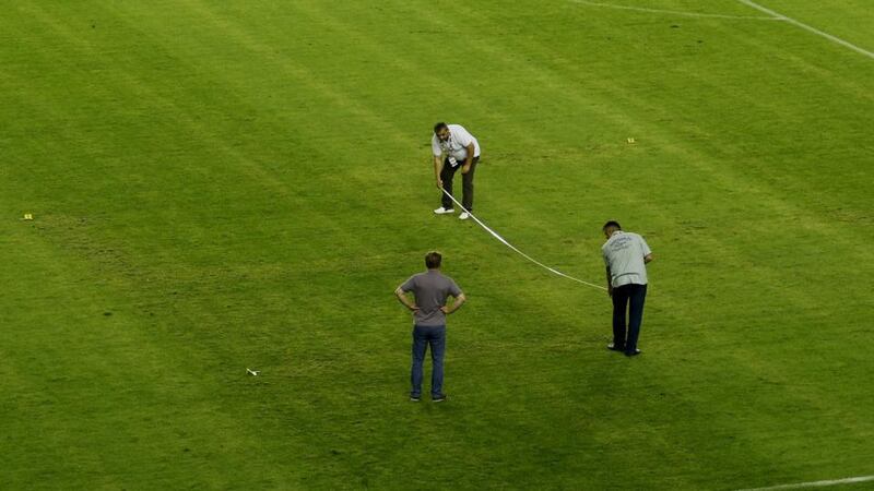 Police officers take measurements on the pitch where the faint pattern of a swastika is seen after the behind closed doors Euro 2016 qualifier between Croatia and Italy at the Poljud Stadium in Split. The Group H fixture was played without any fans present after the Croatians had been given a one-match ban for prior offences. Photo: Antonio Bronic/ Reuters