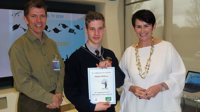 IFI director, Brian Beckett and Eir chief executive Carolan Lennon presenting Michael Williams of St James’s CBS with his certificate following completion of angling course.