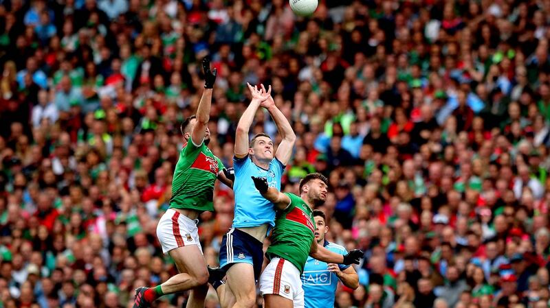 Dublin’s Brian Fenton with Aidan O’Shea and Seamus O’Shea of Mayo. Photograph: Ryan Byrne/Inpho