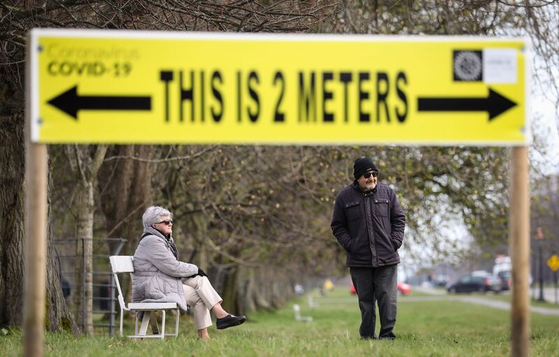 KEEP YOUR DISTANCE: Social distancing advice signage erected in the Phoenix Park in Dublin. Similar advice has in places been painted onto pavements there. Photograph: Crispin Rodwell