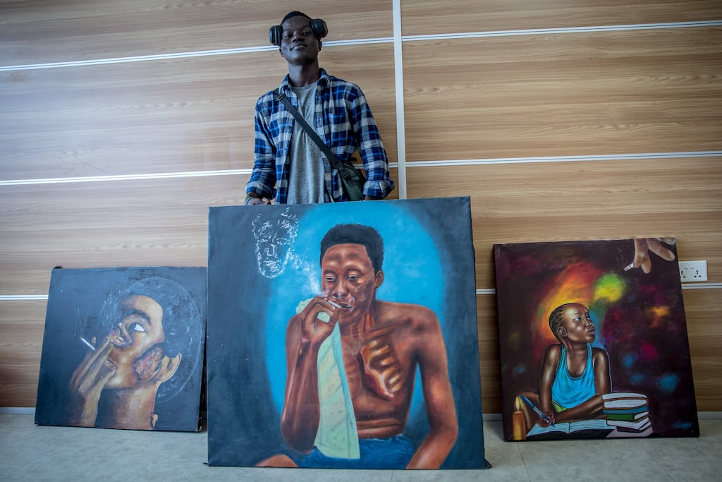 Amos Kamara (25) displays his art raising awareness of the dangers of smoking kush. Photograph: Sally Hayden