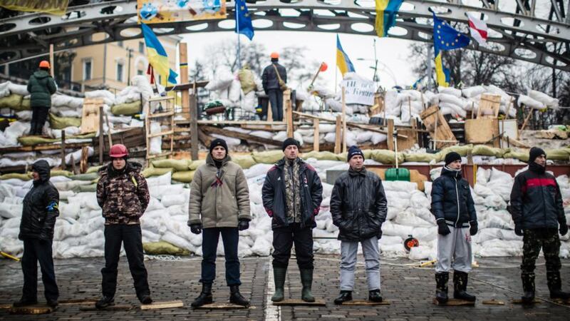 Behind the barricades: anti-government protesters guard a barrier designed to keep police from evicting them from Independence Square in December 2013. Photograph: Brendan Hoffman/Getty