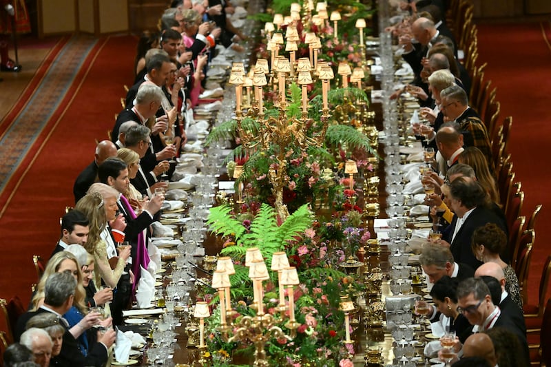Guests raise their glasses for a toast at the banquet. Photograph: Andrew Caballero-Reynolds/WPA Pool/Getty Images