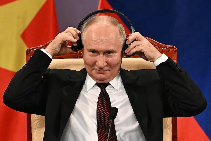 Vladimir Putin adjusts his headphones during an event with Vietnam's president To Lam at the Hanoi Opera House. Photograph: Manan Vatsayana/AFP via Getty Images