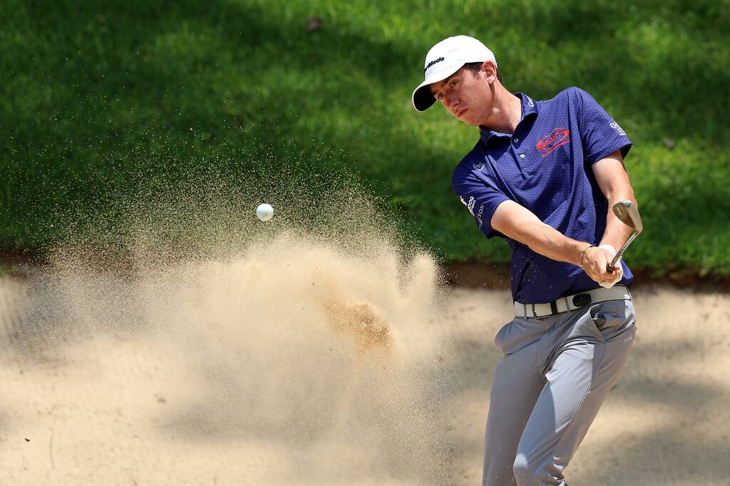 Tom McKibbin of Holywood, Co Down plays a bunker shot on the third hole during the first day of the South African Open Championship. Photograph: Luke Walker/Getty Images