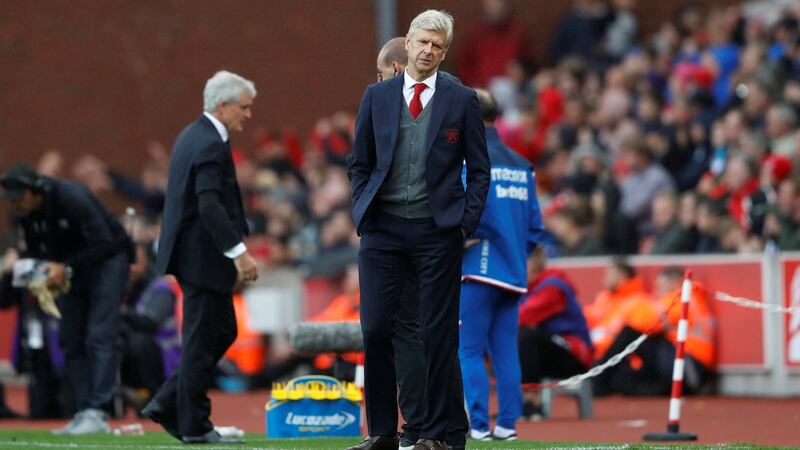 Arsenal manager Arsene Wenger and Stoke City manager Mark Hughes. Photograph: Carl Recine/Reuters