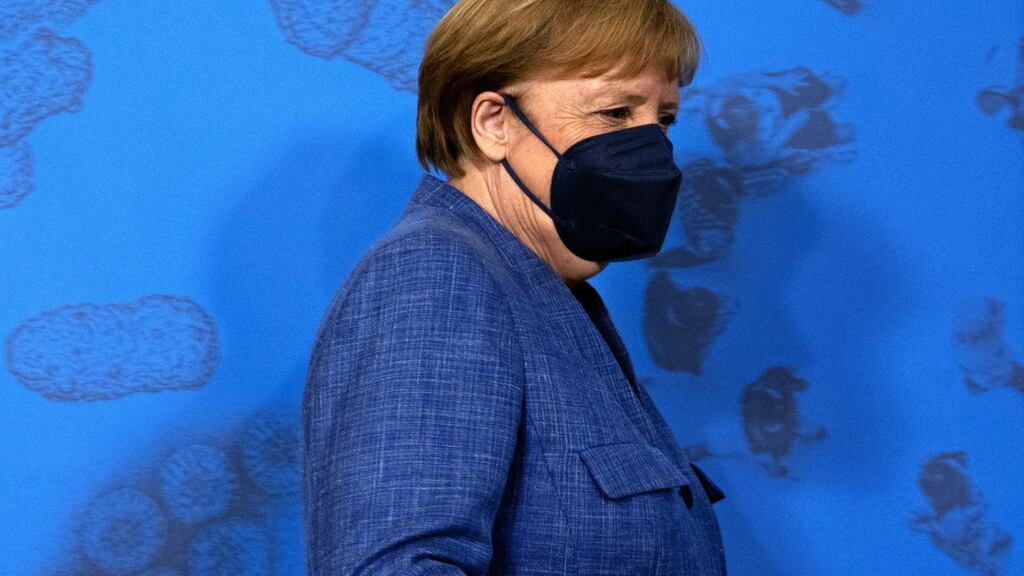 Germany’s chancellor, Angela Merkel, arrives for a news conference at the Robert Koch Institute in Berlin on Tuesday. Photograph: Liesa Johannssen-Koppitz/Bloomberg
