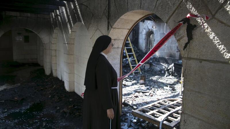 A nun looks at damage caused by a fire in the Church of Loaves and Fishes on the shores of the Sea of Galilee in northern Israel on June 18th. Photograph: Baz Ratner/Reuters