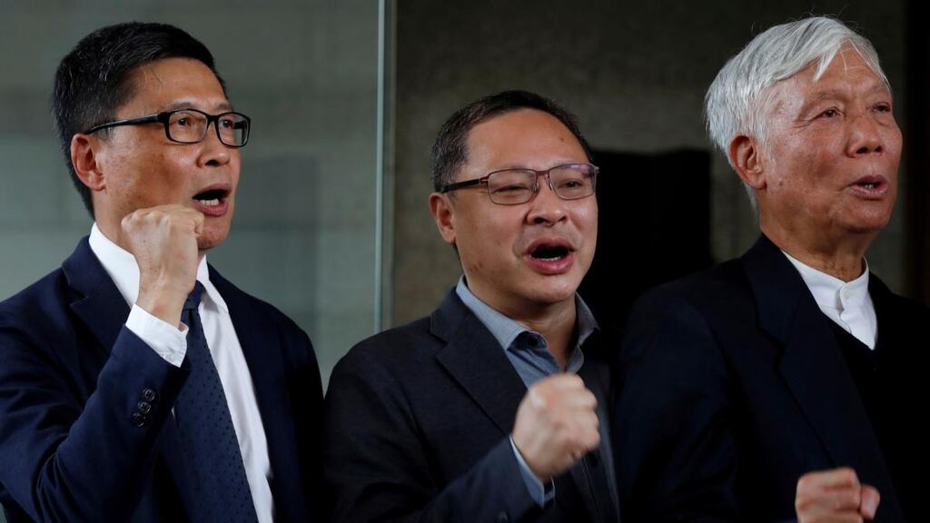 Occupy Central pro-democracy movement founders Chan Kin-man, Benny Tai and Chu Yiu-ming chant slogans after being found guilty  in a Hong Kong court on Tuesday. Photograph:  Tyrone Siu/Reuters
