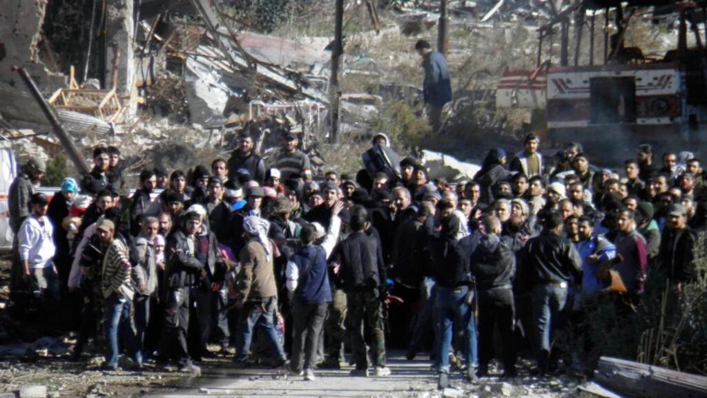 Civilians wait to be allowed to leave a besieged area of Homs earlier this week. Photograph: Thaer Al Khalidiya/Reuters
