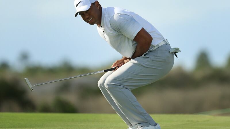 Woods reacts to a missed putt on the 12th green. Photo: Mike Ehrmann/Getty Images