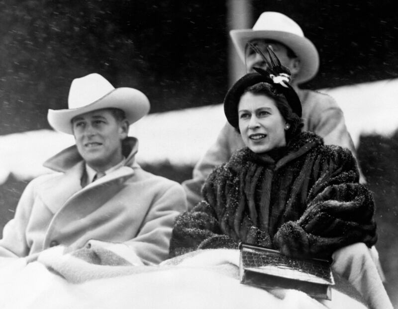Queen Elizabeth II and the Duke of Edinburgh watching a 'stampede' rodeo staged especially for them in Calgary, Alberta, during their tour of Canada in 1951. Photograph: PA