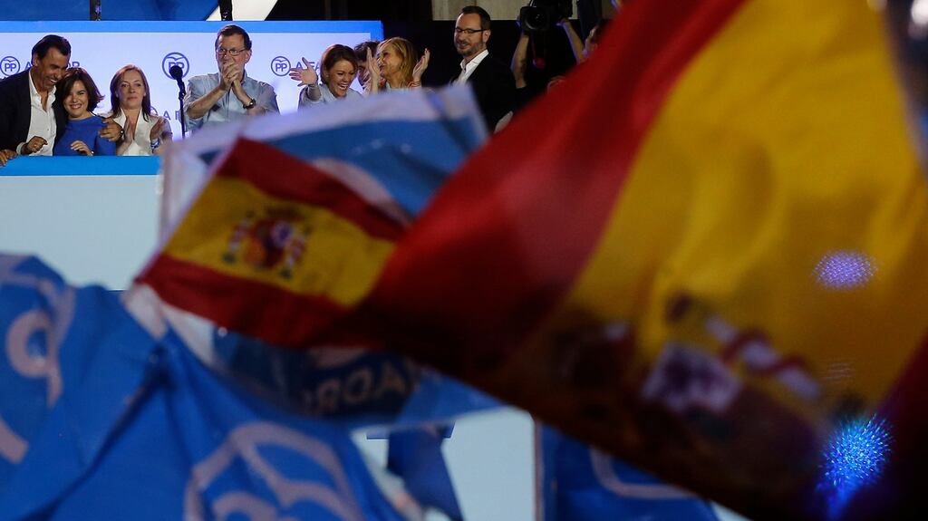 Spain’s acting prime minister and People’s Party candidate Mariano Rajoy, centre, celebrates with party members during the national elections in Madrid. Photograph: AP