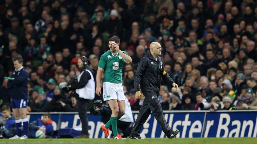 Ireland’s Jonathan Sexton leaves the pitch to be treated for a head injury. Photograph: Ryan Byrne/Inpho