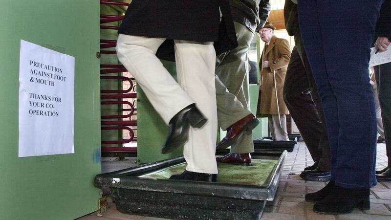 Racegoers disinfect their shoes as a precaution against the foot and mouth virus on arrival at Fairyhouse Racecourse in 2001. Photograph: Matt Kavanagh