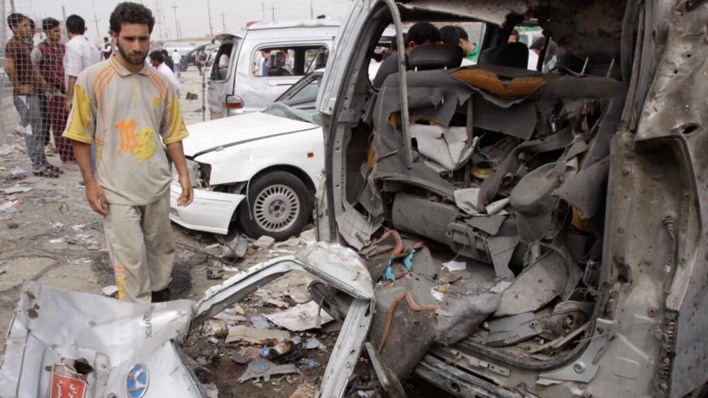 Residents gather at the site of a car bomb blast in Basra, 420 km southeast of Baghdad today. Photograph: Atef Hassan/Reuters