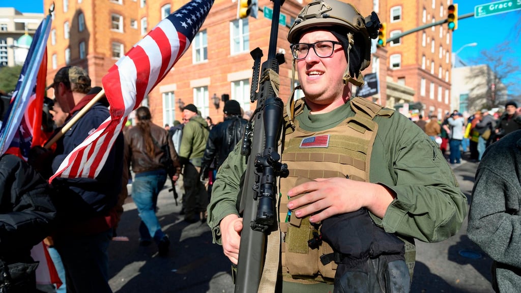 A pro-gun supporter from Buffalo, New York carries a high calibre sniper rifle during a gun rights rally outside the Virginia State Capitol grounds in Richmond, Virginia. Photograph: Roberto Schmidt/AFP