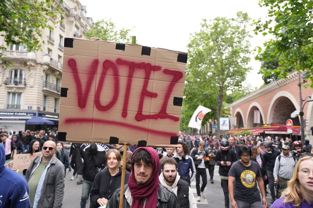 A protester holds a placard during a demonstration against the far-right and racism in central Paris on Saturday. Photographer: Nathan Laine/Bloomberg