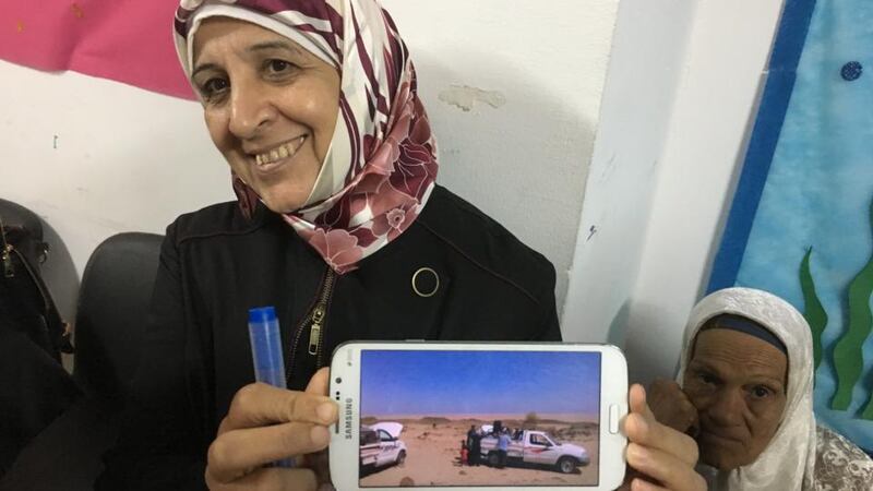 A Syrian refugee in Cairo showing pictures of the flatbed truck which transported her across the border from Sudan to Egypt. Photograph: Paul Cullen