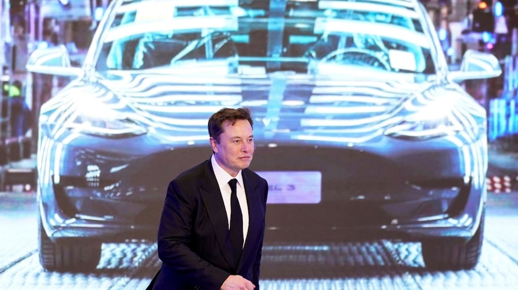 Tesla CEO Elon Musk walks next to a screen showing an image of Tesla Model 3 during an event in Shanghai, China in January. Photograph: Reuters