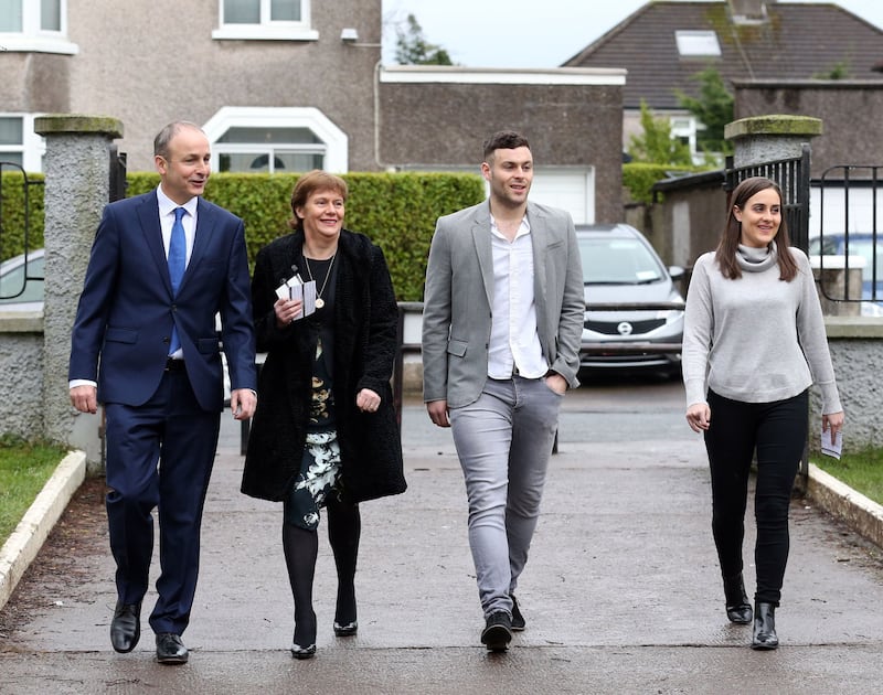 Micheál Martin arrives to cast his vote during the 2016 general election with wife Mary, son Micheál Aodh and daughter Aoibhe