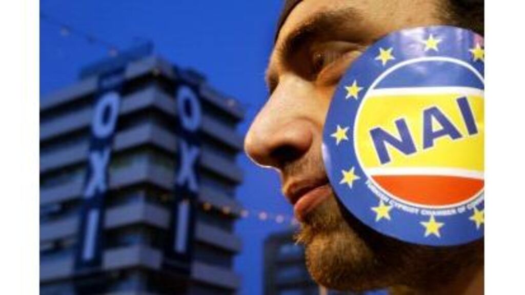 A Greek Cypriot protester with a sticker on his cheek