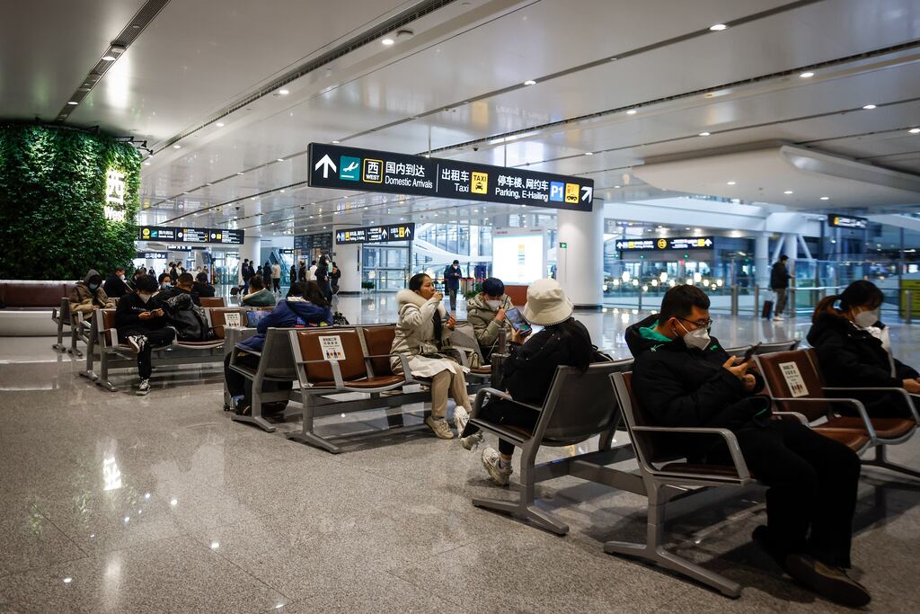 People wait inside Beijing's Daxing International Airport in China, where Covid-19 restrictions on travel are due to be further eased from next month. Photograph: EPA