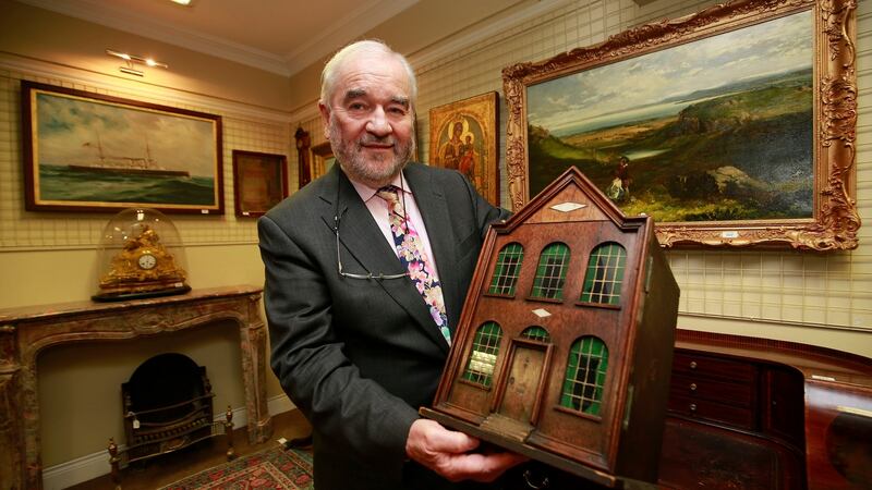 Auctioneer Fonsie Mealy with the doll’s house. Photograph: Nick Bradshaw