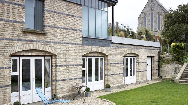 The back wall is in Dolphin's Barn brick with galvanised steel doors leading to the garden