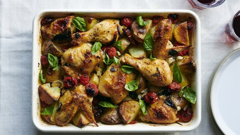 Baked chicken with potatoes, cherry tomatoes and herbs. Photograph: David Malosh/The New York Times.