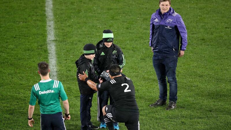Maori All Blacks captain Ash Dixon presents Anthony Foley’s children Dan and Tony with a jersey with his initials on it at Thomond Park. Photograph: Billy Stickland/Inpho