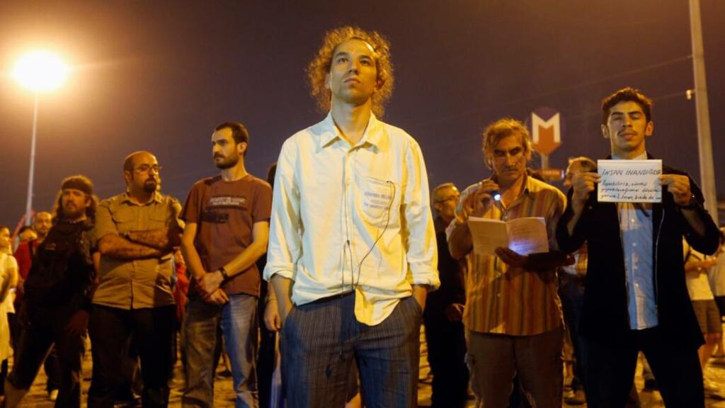 People stand during a silent protest at Taksim Square in Istanbul yesterday. Photograph: Reuters
