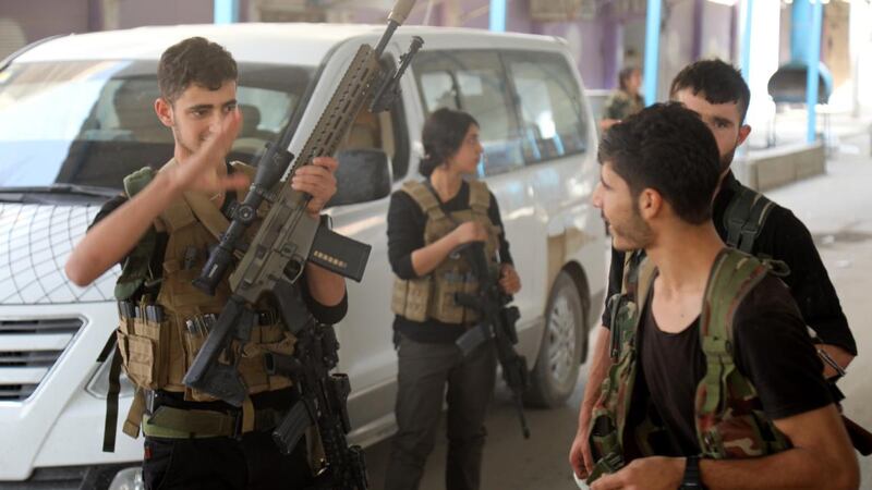 Kurdish fighters of the Syrian Democratic Forces gather in al-Ein, northern Syria on Friday. Photograph: EPA