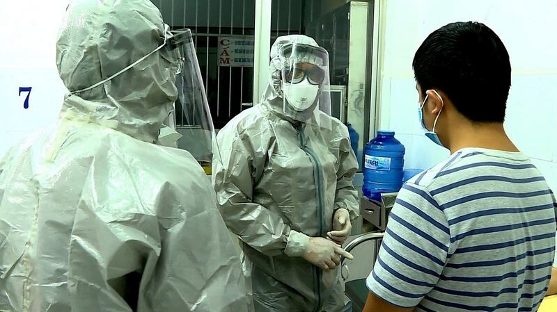 Officials from Vietnam talk to a man tested positive for the Wuhan coronavirus, at an isolated section at Cho Ray hospital, in Ho Chi Minh city, Vietnam, January 23rd, 2020. Photograph: EPA