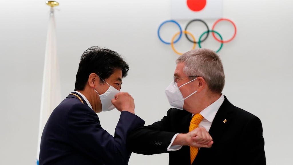 International Olympic Committee (IOC) president Thomas Bach (R) and Japan’s former prime minister Shinzo Abe bump fists during a ceremony at the Japan Olympic Museum in Tokyo. Photo: Kim Kyung-Hoon/AFP via Getty Images