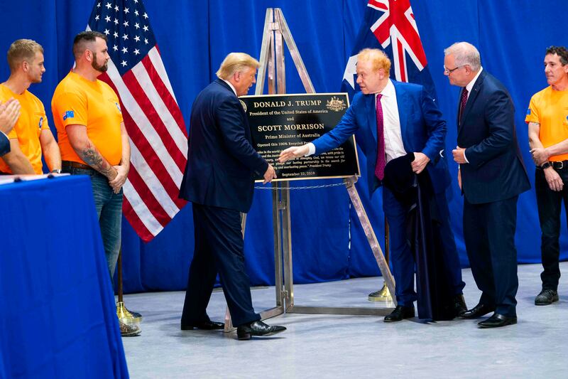 Former US president Donald Trump shakes hands with Anthony Pratt, the owner of Pratt Industries, as former Australian prime minister Scott Morrison looks on, during a tour of a Pratt Industries plant in Ohio in 2019. Photograph: Doug Mills/New York Times