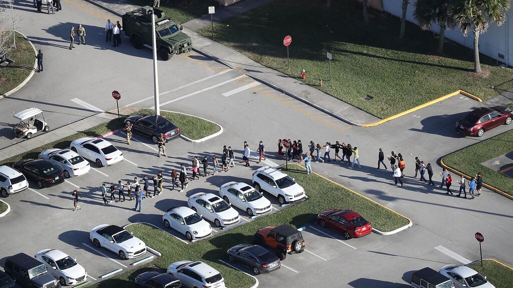 People are brought out of the Marjory Stoneman Douglas High School in Florida after a multiple-fatality shooting at the school. Photograph: Joe Raedle/Getty Images