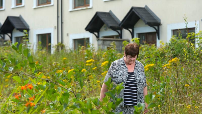 Ghost estate: shopkeeper Joan Walsh at an abandoned development in Boherbue, Co Cork. Photograph: Michael Mac Sweeney/Provision