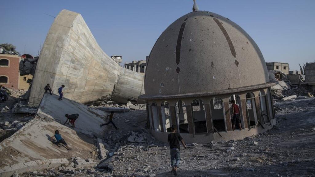Palestinian children play in the ruins of a demolished mosque and water tower in Khuza’a, Gaza. Photograph: Dan Kitwood/Getty Images