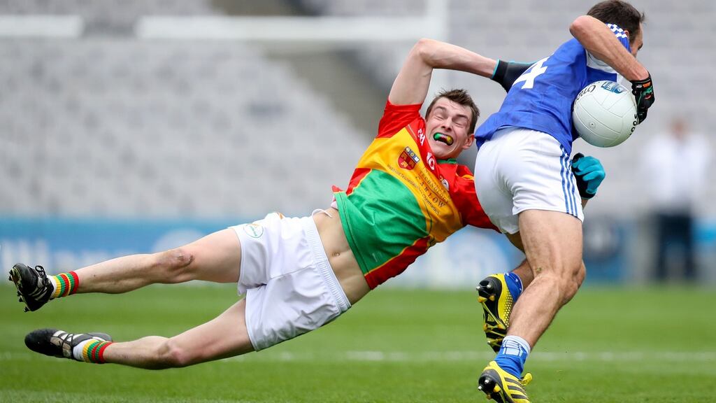 Carlow’s Sean Gannon tackles Gareth Dillon in the Division Four final. Photograph: Oisin Keniry/Inpho