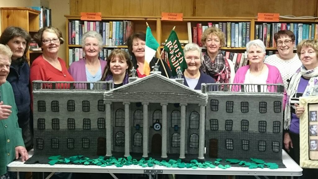 Members of the Knit & Natter group who meet every Friday at Dunmanway Library pictured with the stunning replica model of Dublin’s GPO, knitted and crocheted by them. Photograph courtesy of the Southern Star