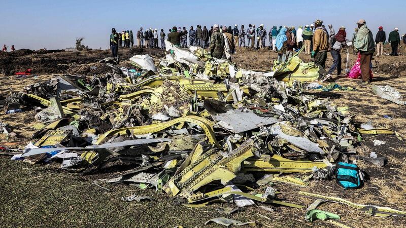 People stand at the crash site of Ethiopia Airlines flight 302, near Bishoftu south of Addis Ababa, in which 157 people died. Photograph: MichaelTewelde/AFP/Getty Images