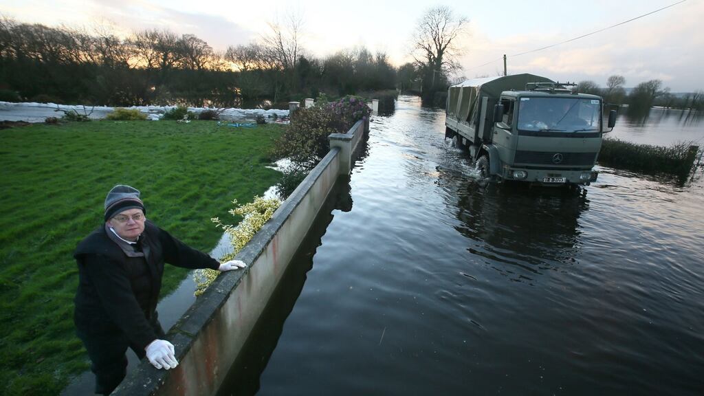 A local man looks at the heavily flooded road near Springfield, Co Clare. Photograph: Brian Lawless/PA Wire