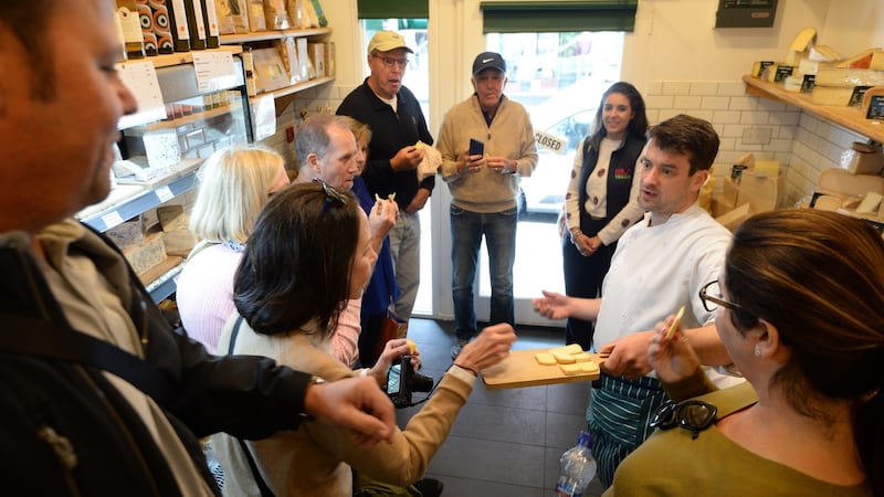The group samples some cheeses from Sheridan’s Cheesemongers, served up by Michael Conefrey. Photograph: Dara Mac Dónaill