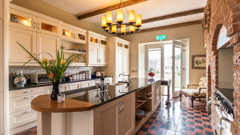 At Thomond House in Co Clare, bare brick has been exposed to give texture to the warm russet walls.