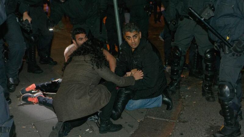 A severely injured protester is protected by two men and a woman during violent clashes between Kurds, protesting the Islamic State (IS) onslaught on Kobani in Syria, and radical islamic Salafists in Hamburg, Germany, this morning. Photograph: EPA