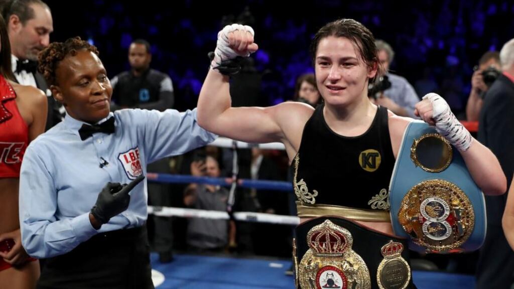 Katie Taylor with her WBA and IBF belts after her unanimous points win over Victoria Bustos. Photograph: Elsa/Getty