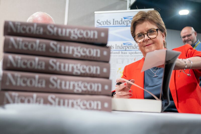 Former first minister Nicola Sturgeon signs copies of her book, Frankly, at the SNP annual conference earlier this week. Photograph: Jane Barlow/ PA Wire