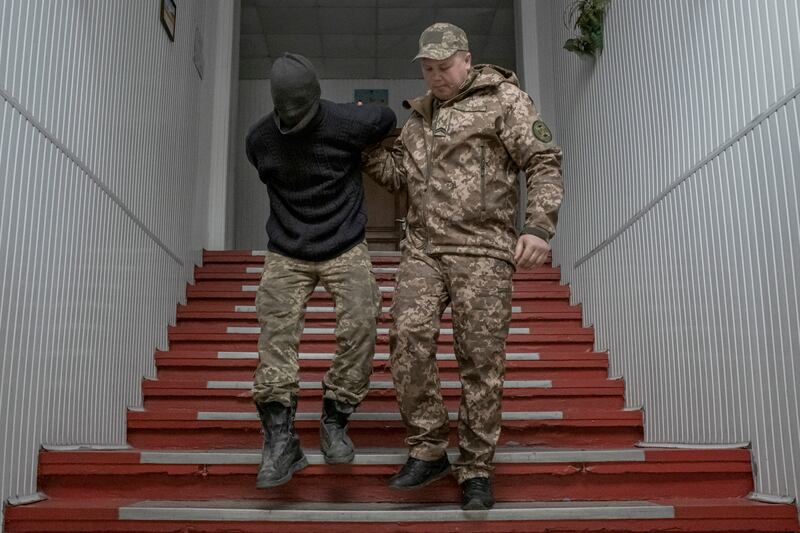 A captured Wagner fighter loyal to Russian forces is escorted by a Ukrainian guard at a prison in Dnipro in April. Photograph: Mauricio Lima/New York Times